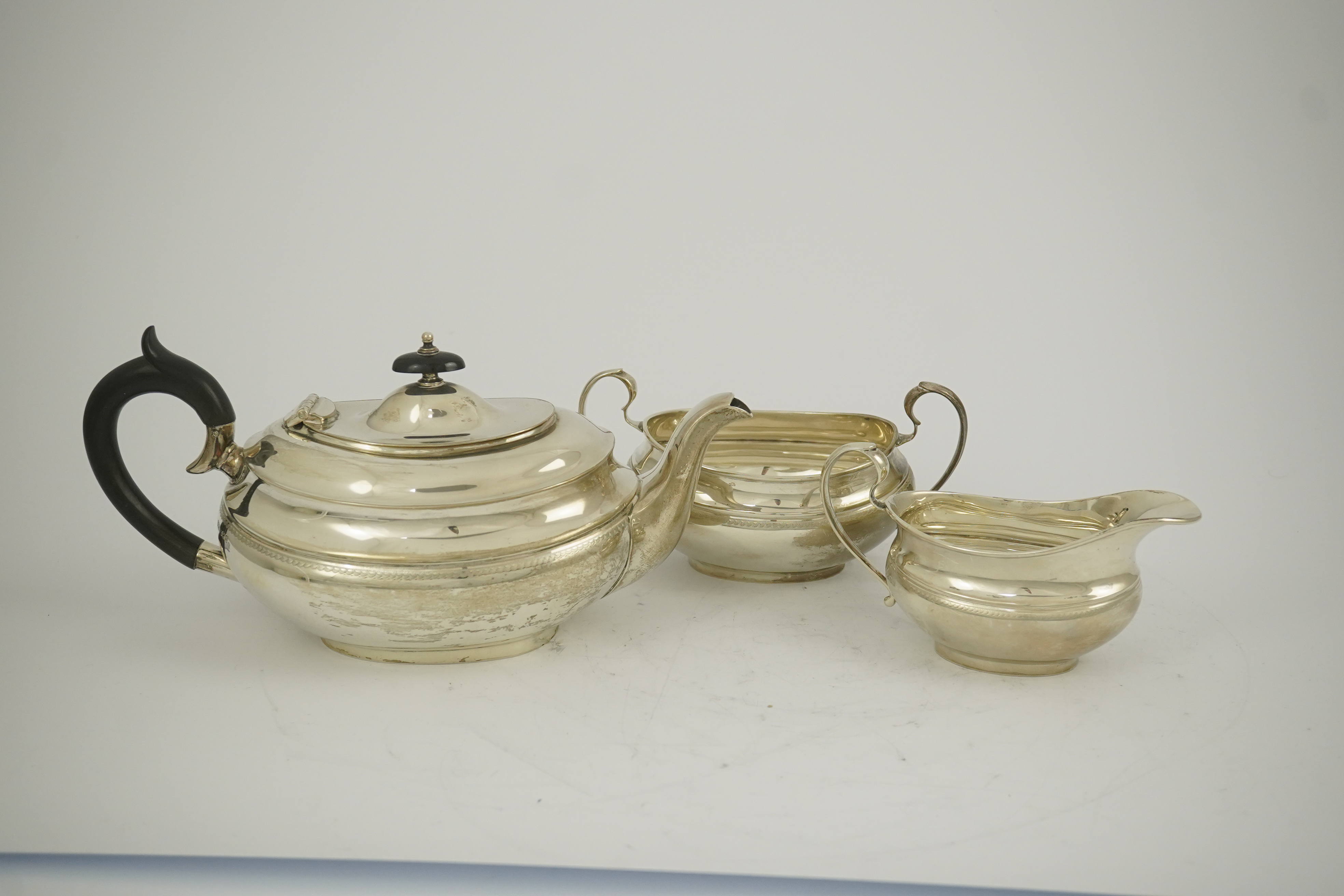 A George V silver three piece oval tea set, by Viners Ltd